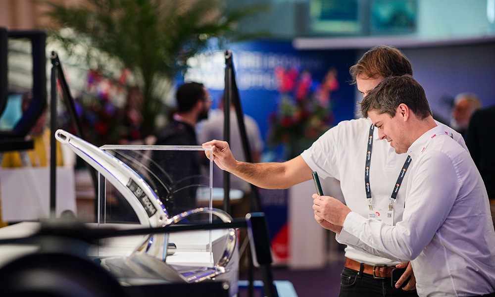 Two men examine a marine product display at Metstrade.