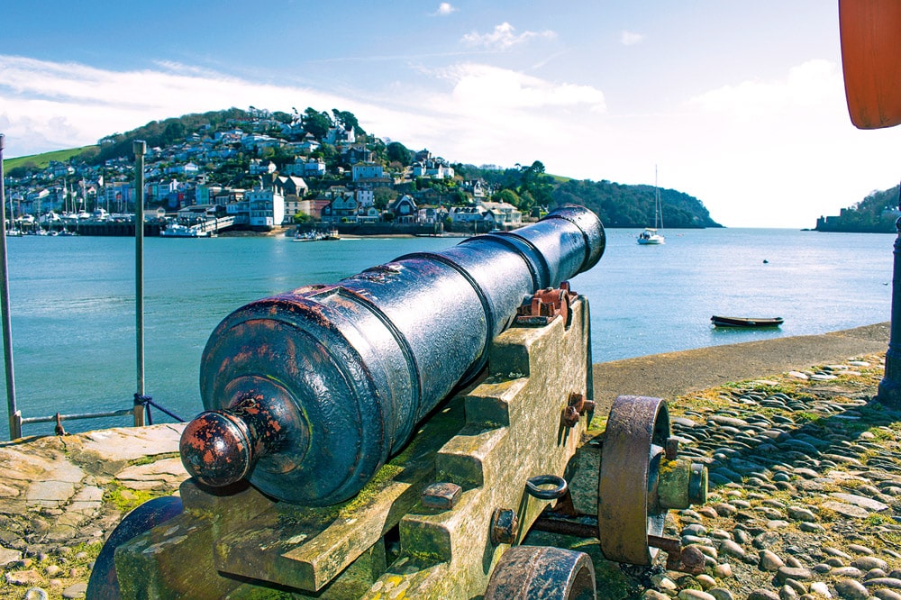 Looking out to sea, an original cannon on the quay. Dartmouth, River Dart