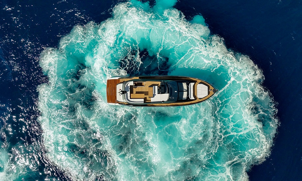 Sessa Marine's F60 performing a high-speed turn, creating a circular wake in vivid blue water, viewed from directly above.