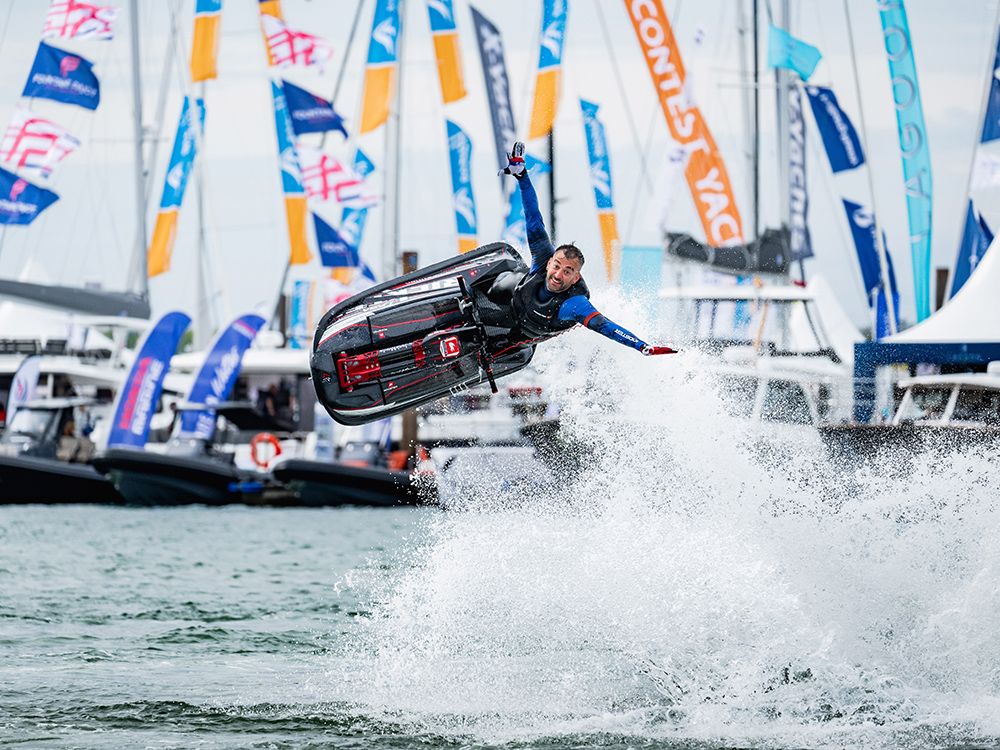 Jet ski rider launches into the air performing a freestyle stunt at Southampton International Boat Show.