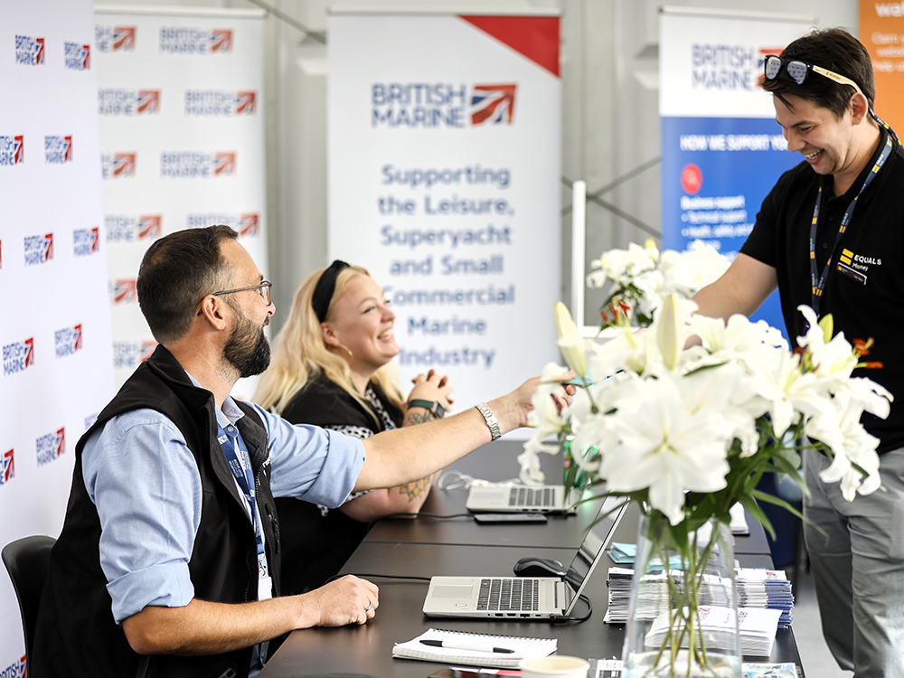 British Marine staff welcoming ones at Southampton International Boat Show trade registration desk.