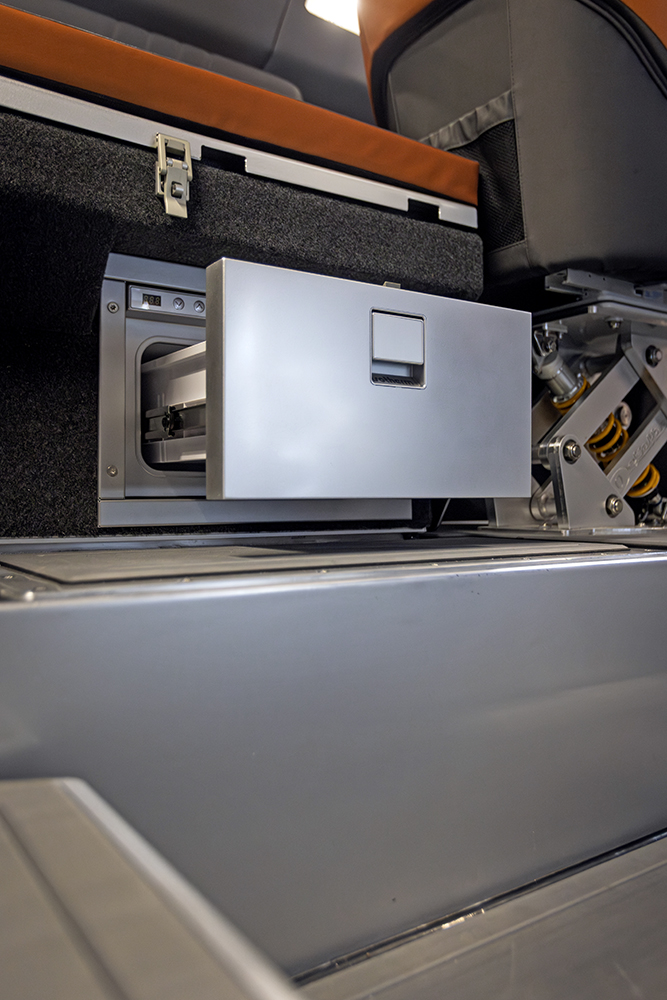 Pull-out drawer fridge integrated into Ockelbo B25 CAB cabin seating base.