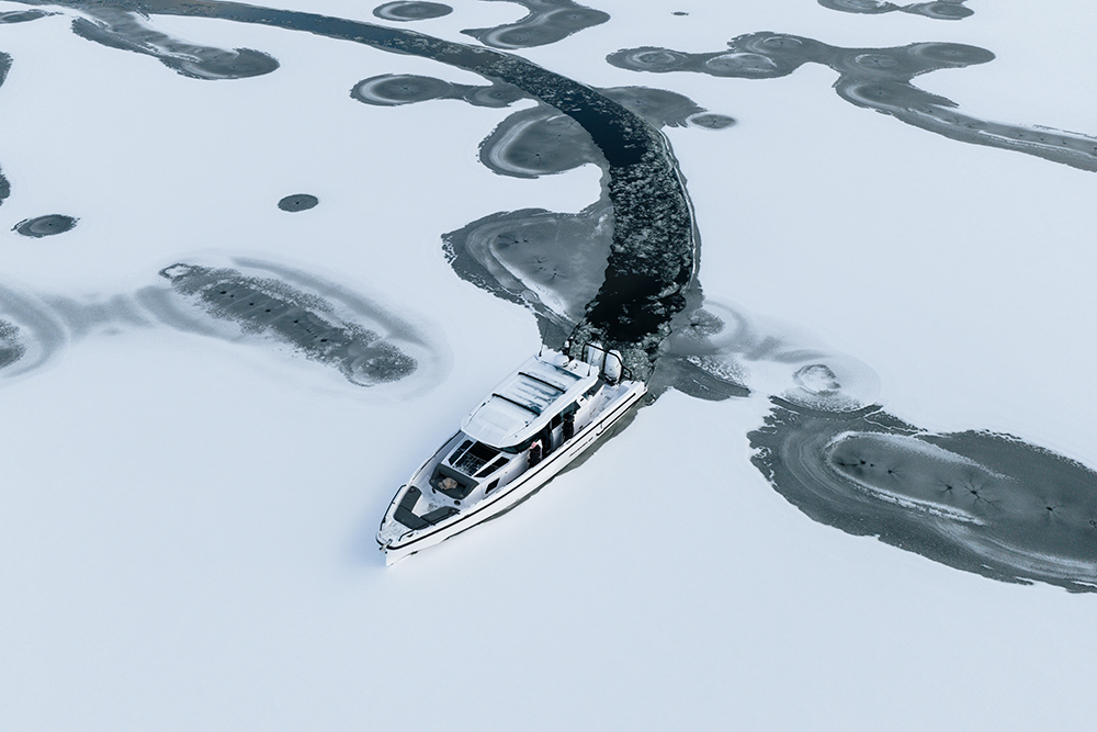 Overhead view of Axopar 38 XC Cross Cabin navigating frozen waters, demonstrating winter capability, stability and all-season adventure design.