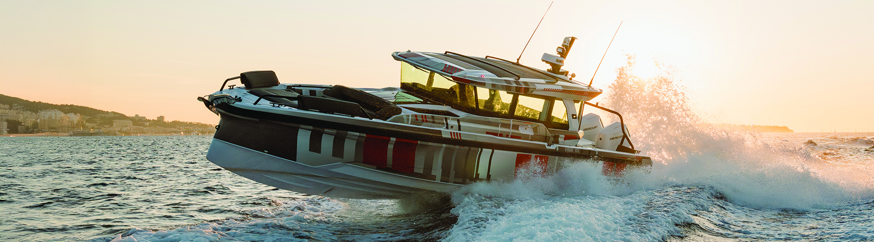 Axopar 38 underway plunging through a sea in the sunset